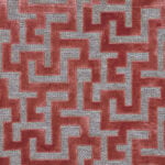 Tejido con motivos geométricos y efecto terciopelo en coral